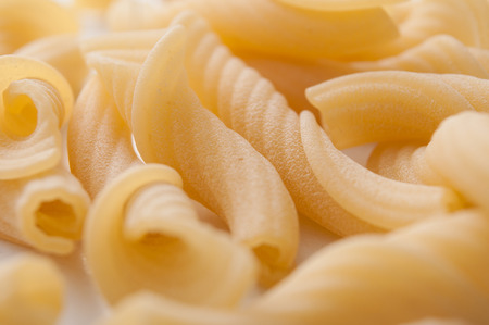 Closeup of penne pasta on white backgroundの写真素材