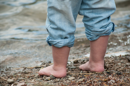 closeup of feet of child playing on the beachの写真素材