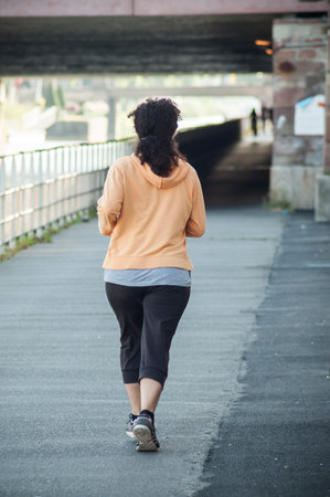 Mulhouse - France - 27 June 2018 - Woman running in border channelのeditorial素材