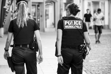 Mulhouse - France - 4 July 2018 -  police women  walking in main place on back viewのeditorial素材