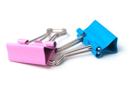 closeup of pink and blue paperclips on white backgroundの写真素材