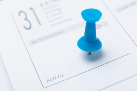 closeup of blue pin in agenda on 31 December dateの写真素材