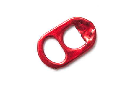 closeup of red piece of alumnium can for recycling on white background