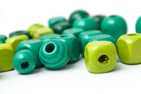 closeup of green wooden beads on white backgroundの写真素材