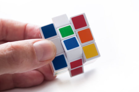 Mulhouse - France - 27 September 2018 - closeup of Rubik's cube in hand on white backgroundのeditorial素材