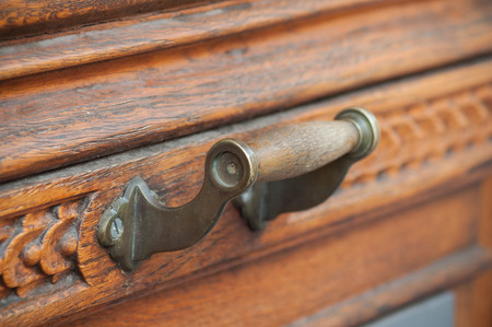 closeup of bronze handle on wooden door