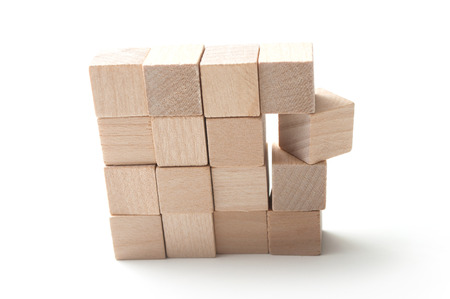 closeup of  piece of wooden brick of construction game on white backgroundの写真素材