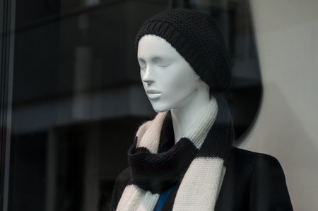closeup of mannequin with winter hat in fashion store showroomの写真素材