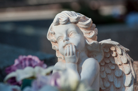 closeup of stoned angel on tomb in a cemeteryの写真素材