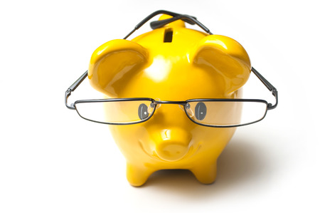 closeup of yellow piggy bank on white backgroundの写真素材