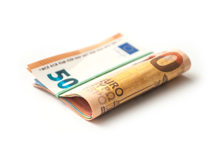 closeup of banknotes bundle of fifty euros money on white backgroundの写真素材