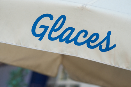 closeup of ice cream store front sign in french text ( glaces, traduction of ice cream)の写真素材