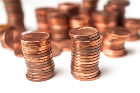 closeup of cents of euro coins piles on white background