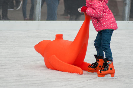 retail of legs of girl slipping on an ice christmas rinkの写真素材