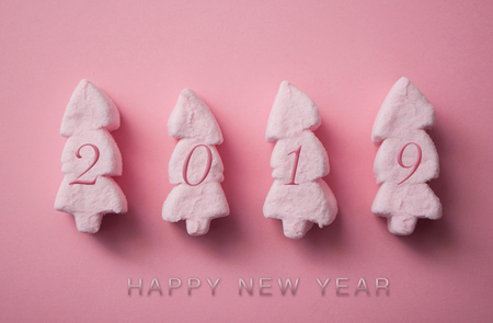 greeting 2019 card with pink marshmallows in shaped fir on pink backgroundの写真素材