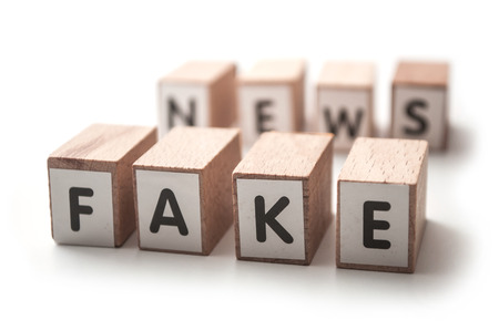 closeup of wooden letters on white background - concept fake newsの写真素材