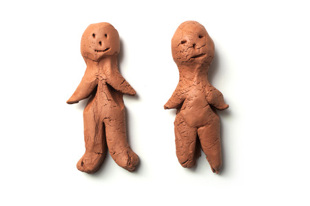 closeup of terra cotta characters in shaped men on white backgroundの写真素材