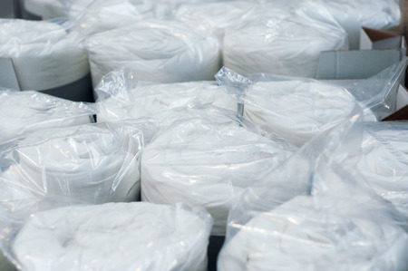 closeup of white set of bed linen rolls in decoration storeの写真素材