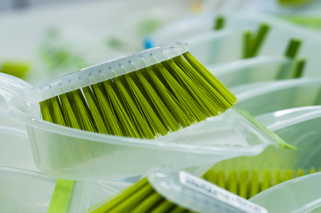 closeup of green brush and plastic dust shovel stack in decoration storeの写真素材