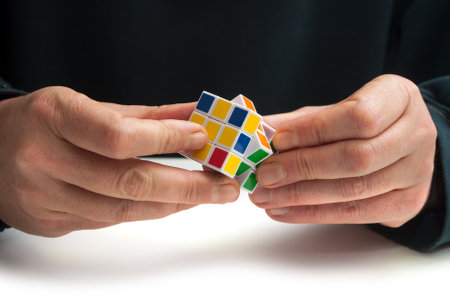 Mulhouse - France - 16 December 2018 - Rubik's cube in hand of man on white tableのeditorial素材
