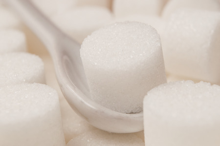 closeup of sugar in shaped circle in white spoonの写真素材