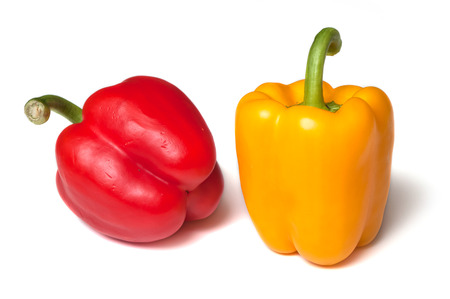 closeup of red and yellow peppers on white background の写真素材