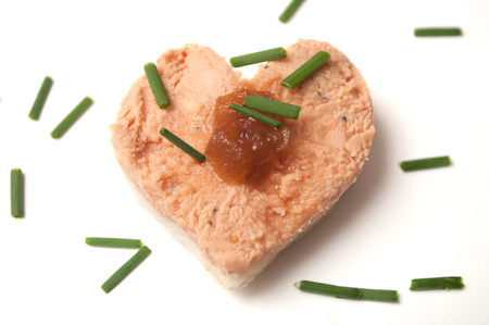 closeup of foie gras on bread in shaped heart onwhite backgroundの写真素材