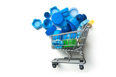 closeup of blue plastic plugs in mini supermarket trolley - plastic consumption conceptの写真素材