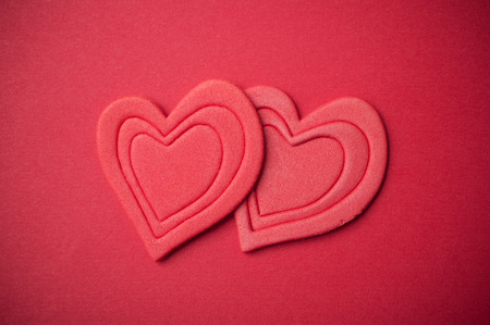 closeup of two red hearts on red paper  background - Valentine's day conceptの写真素材