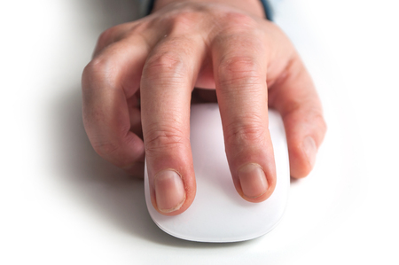 closeup of hand of man on white mouse on white backgroundの写真素材