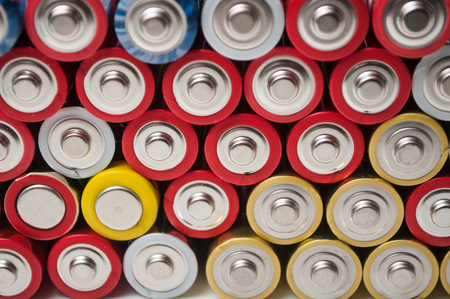 closeup of red and silver aa alkaline batteries stack on full frameの写真素材