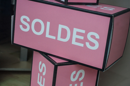 closeup of discount sign "SOLDES" in french,  the traduction of  (sales ) pink boxes in french fashion store showroomの写真素材