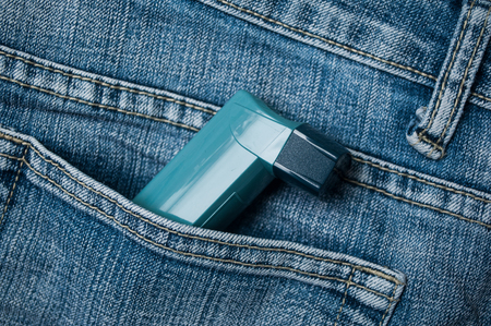 closeup of asthma aerosol in blue jeans pocketの写真素材