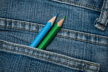 closeup of colouring pencils in blue jeans pocketの写真素材