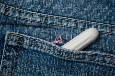 Closeup of hygienic tampon in blue jeans pocketの写真素材