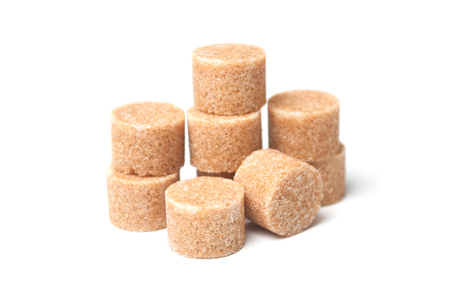 group of brown cane sugar in shaped circle on white backgroundの写真素材