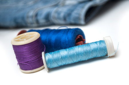 closeup of sewing thread spool bobbin on white backgroundの写真素材