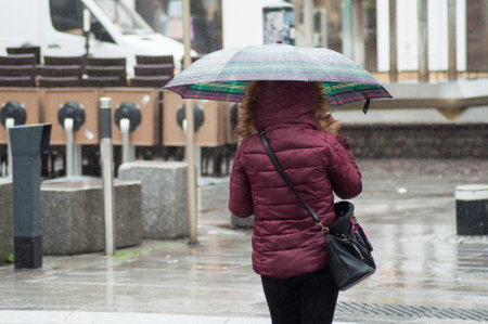 Mulhouse - France - 15 March 2019 - portrait of woman walking with  umbrella in the pedestrian streetのeditorial素材