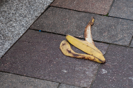 closeup of banana skin on pavement in the streetの写真素材