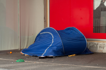 closeup of homeless in blue igloo tent in the cityの写真素材