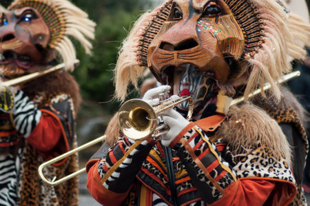 Pfastatt - France - 17 March 2019 - portrait of people playing music with with mask of lion parading in the streetのeditorial素材
