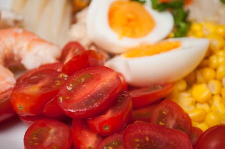 closeup of roma tomatoes and hard boiled eggs in a plateの写真素材