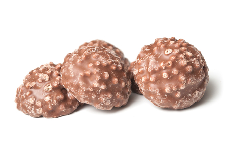 closeup of milk chocolate in shaped rock on white backgroundの写真素材