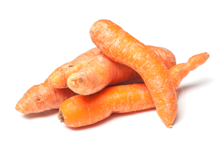 closeup of deformed carrots on white backgroundの写真素材