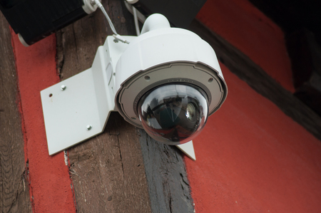 closeup of brown security cameras of security on urban background