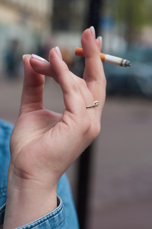 closeup of woman with cigarette in outdoor の写真素材