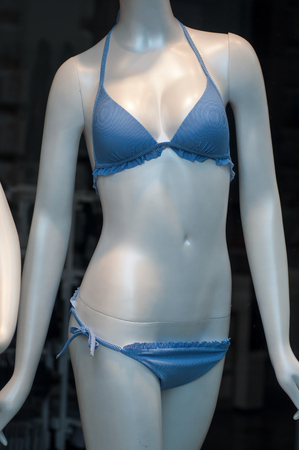 closeup of blue stripped bikini on mannequin in fashion store showroom for womenの写真素材