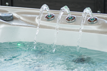 closeup of jet of water in swirl bathの写真素材
