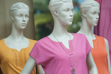 closeup of colorful teeshirt on mannequin in fashion store for women showroomの写真素材