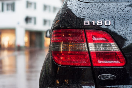Mulhouse - France - 15 May 2018 - closeup of rain drops on black Mercedes B180  rear light parked in the streetのeditorial素材